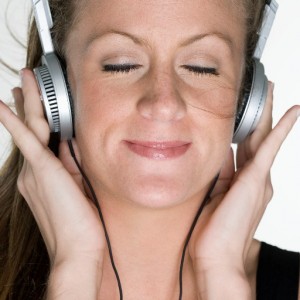 Woman Listening to Headphones --- Image by © Royalty-Free/Corbis